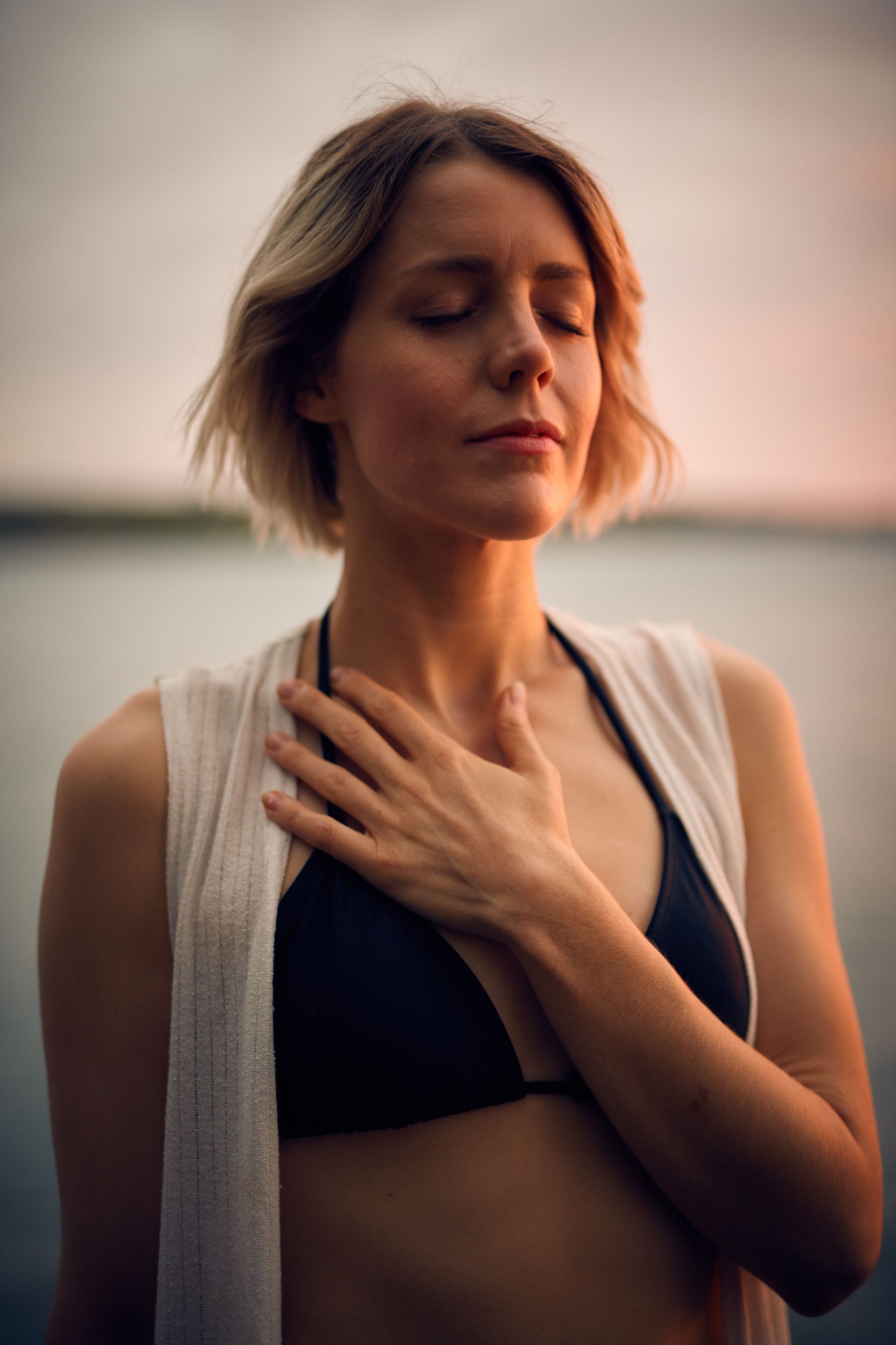 a woman with her hand on her chest